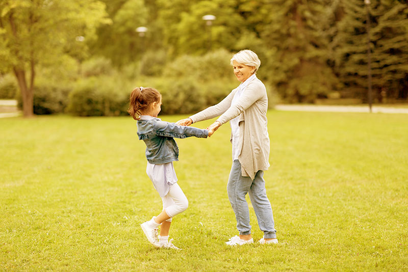 Image of Grandmother and Grandaughter dancing tinted yellow